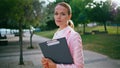 Portrait confident businesswoman standing park with folder. Calm business lady Royalty Free Stock Photo