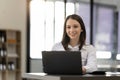 Portrait confident businesswoman working on laptop at her workplace at modern office. Royalty Free Stock Photo