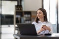 Portrait confident businesswoman working on laptop at her workplace at modern office. Royalty Free Stock Photo