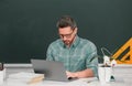 Portrait of confident caucasian male teacher in classroom. Middle aged man professor at high school. Royalty Free Stock Photo