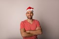 Portrait of a confident cheerful man in red Canta Clause hat Royalty Free Stock Photo