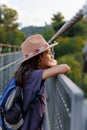 portrait of a confident child. a boy in a hat stands on a bridge and dreams