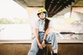 Portrait confident, cool young female skateboarder at outdoor skate park. Urban girl with skate board on half pipe ramp. lifestyle Royalty Free Stock Photo