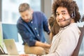 Portrait of confident customer service representative with colleagues in background at office Royalty Free Stock Photo