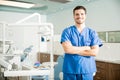 Portrait Of Confident Dentist Standing With Arms Crossed In Clinic Royalty Free Stock Photo