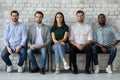 Portrait confident diverse candidates sitting in row, waiting for interview