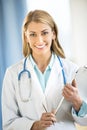 Portrait Of Confident Doctor Holding Clipboard Royalty Free Stock Photo