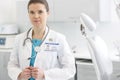 Portrait of confident doctor in labcoat with stethoscope at dental clinic