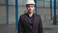 Portrait confident factory manager wearing suit and safety helmet