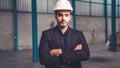 Portrait confident factory manager wearing suit and safety helmet