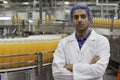 Portrait of confident factory worker standing with arms crossed