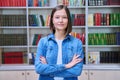 Portrait of confident female college student inside library in educational building Royalty Free Stock Photo