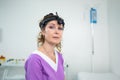 Portrait of confident female doctor. Female ENT doctor in purple medical clothes posing in office of the clinic on her Royalty Free Stock Photo