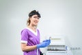 Portrait of confident female doctor. Female ENT doctor in purple medical clothes posing in office of the clinic on her Royalty Free Stock Photo