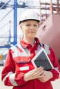 Portrait of confident female engineer holding tablet computer in shipping yard