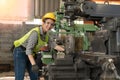 Portrait of confident female worker wearing hard hat and safety glasses working in industrial