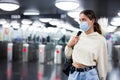 Confident girl in a protective mask entered the subway, passing through the turnstile Royalty Free Stock Photo