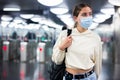Confident girl in a protective mask entered the subway, passing through the turnstile Royalty Free Stock Photo