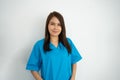 Portrait Of confident, happy, and smiling Asian medical woman doctor or nurse wearing blue scrubs uniform over isolated white Royalty Free Stock Photo