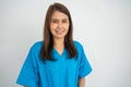 Portrait Of confident, happy, and smiling Asian medical woman doctor or nurse wearing blue scrubs uniform over isolated white Royalty Free Stock Photo