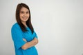 Portrait Of confident, happy, and smiling Asian medical woman doctor or nurse wearing blue scrubs uniform over isolated white Royalty Free Stock Photo