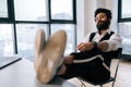 Portrait of confident Indian businessman sitting at office desk with feet up on table with laptop, finished work, job Royalty Free Stock Photo