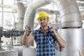 Portrait of confident industrial worker holding wrench