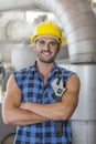 Portrait of confident industrial worker standing arms crossed