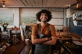 Portrait of confident male barista standing with arms crossed at coffee house Royalty Free Stock Photo