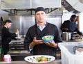 Chef with cooked dish Royalty Free Stock Photo