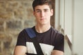 Portrait of confident male leaning on window