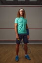 Portrait of confident male squash player standing with racket ready for game Royalty Free Stock Photo