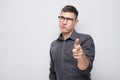 Portrait of confident man chooses you points finger at camera isolated on white studio background. Welcome gesture Royalty Free Stock Photo