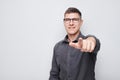 Portrait of confident man chooses you points finger at camera isolated on white studio background. Welcome gesture Royalty Free Stock Photo