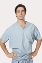 Portrait of confident man in surgical scrubs standing against gray background Royalty Free Stock Photo