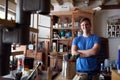 Portrait Of Confident Man Working In Workshop On Upcycling And Craft Projects