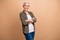 Portrait of confident mature age businesswoman wear khaki shirt folded arms smiling in office satisfied isolated on Royalty Free Stock Photo