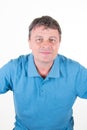 Portrait of confident mature man in blue shirt standing on white background Royalty Free Stock Photo