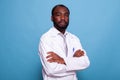 Portrait of confident medical doctor in white lab coat on blue background Royalty Free Stock Photo