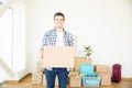 Confident Man Carrying Cardboard Box At Newly Purchased Home Royalty Free Stock Photo