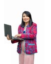 Portrait confident middle-aged Asian woman wearing pink casual wear using laptop isolated on white background Royalty Free Stock Photo