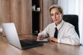 Portrait of confident middle-aged business woman using computer remote for business studying, watching online virtual Royalty Free Stock Photo