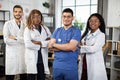 African American, Indian and Arabian medical students posing at camera in modern conference room Royalty Free Stock Photo