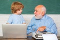 Portrait of confident old male teacher. Teacher helping his teen pupil on education class. Young boy doing his school Royalty Free Stock Photo