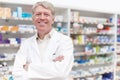 Pharmacist smiling with confidence. Portrait of confident pharmacist smiling with hands folded at drugstore. Royalty Free Stock Photo