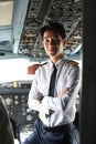 Portrait of confident pilot is smiling and posing in the cockpit of an airplane Royalty Free Stock Photo