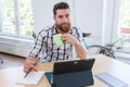 Portrait of a confident self-employed young man sitting at desk