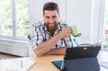 Portrait of a confident self-employed young man sitting at desk