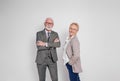 Portrait of confident senior businessman and businesswoman smiling and posing over white background Royalty Free Stock Photo