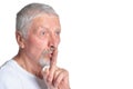 Portrait of confident senior man gesturing silence Royalty Free Stock Photo